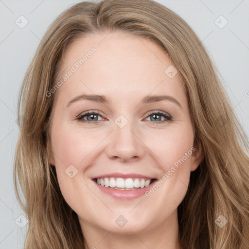 Joyful white young-adult female with long  brown hair and blue eyes