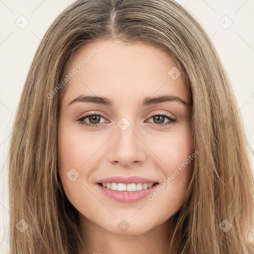 Joyful white young-adult female with long  brown hair and brown eyes