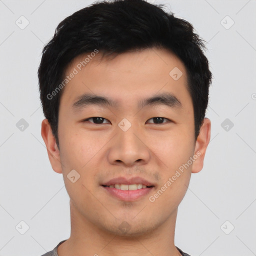 Joyful asian young-adult male with short  black hair and brown eyes