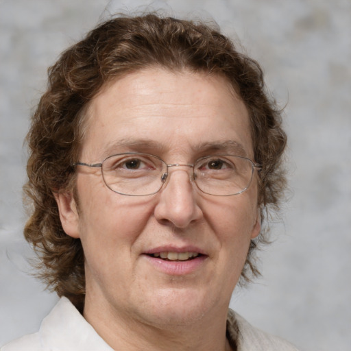 Joyful white middle-aged male with medium  brown hair and brown eyes