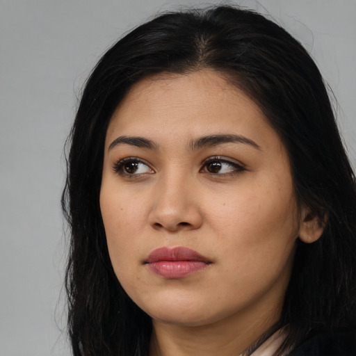 Neutral latino young-adult female with long  black hair and brown eyes