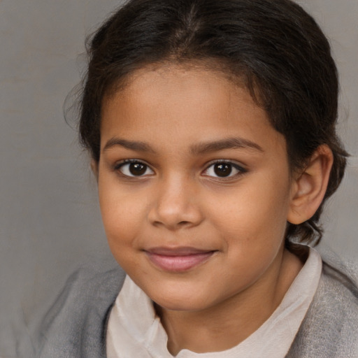 Joyful white child female with medium  brown hair and brown eyes