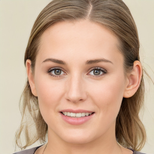 Joyful white young-adult female with medium  brown hair and grey eyes