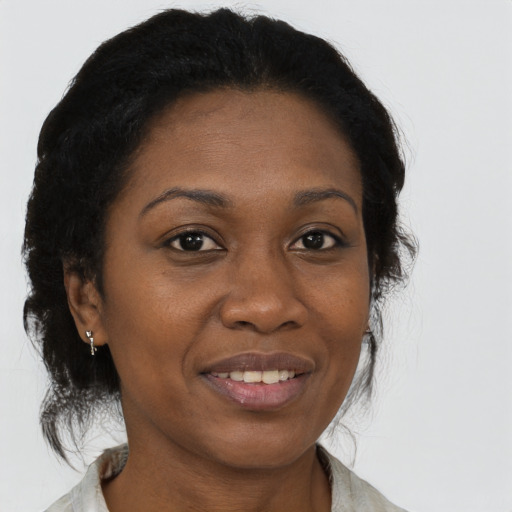 Joyful black adult female with medium  brown hair and brown eyes