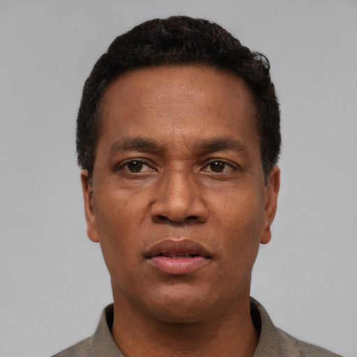 Neutral latino adult male with short  black hair and brown eyes