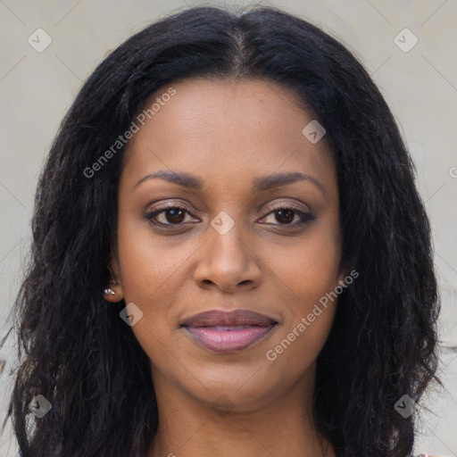 Joyful black young-adult female with long  brown hair and brown eyes