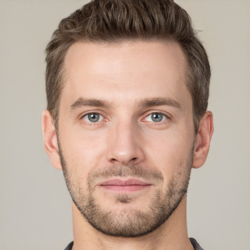 Joyful white young-adult male with short  brown hair and grey eyes