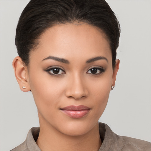 Joyful latino young-adult female with short  brown hair and brown eyes