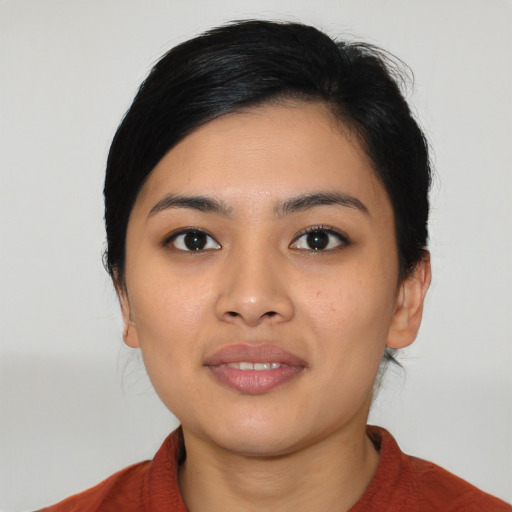 Joyful asian young-adult female with medium  black hair and brown eyes