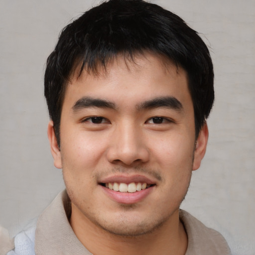 Joyful asian young-adult male with short  black hair and brown eyes