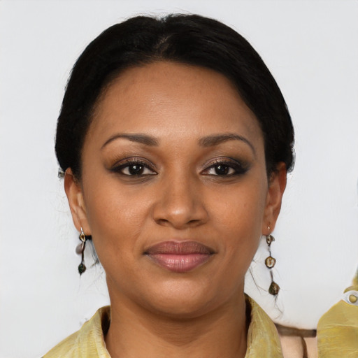 Joyful black young-adult female with long  brown hair and brown eyes