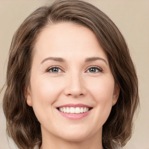 Joyful white young-adult female with medium  brown hair and green eyes