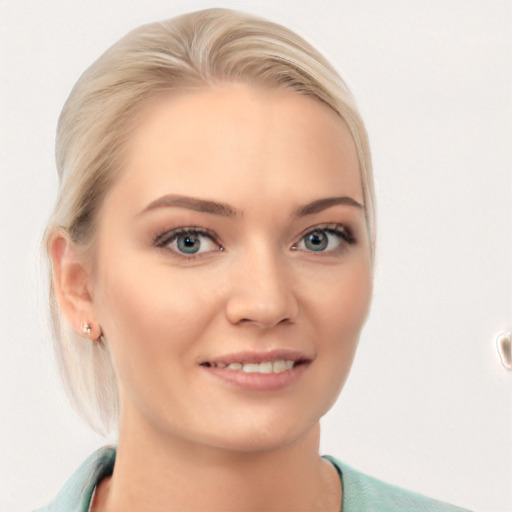 Joyful white young-adult female with medium  blond hair and blue eyes