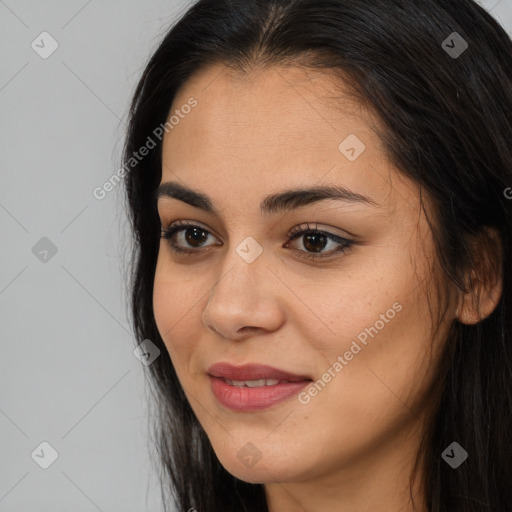 Joyful asian young-adult female with long  brown hair and brown eyes