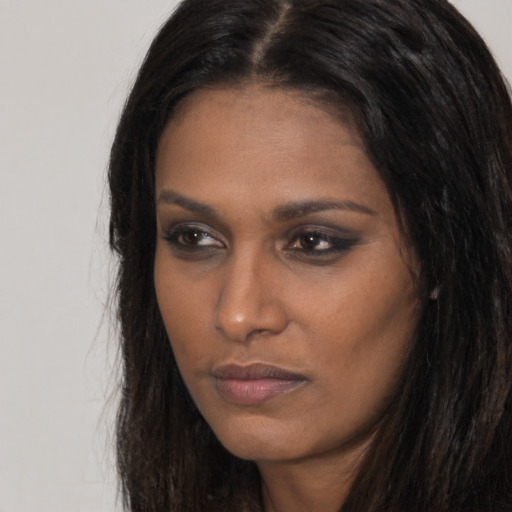 Neutral black young-adult female with long  brown hair and brown eyes