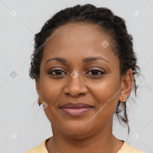 Joyful black young-adult female with long  brown hair and brown eyes