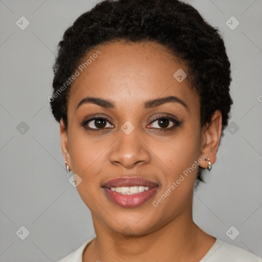 Joyful black young-adult female with short  black hair and brown eyes