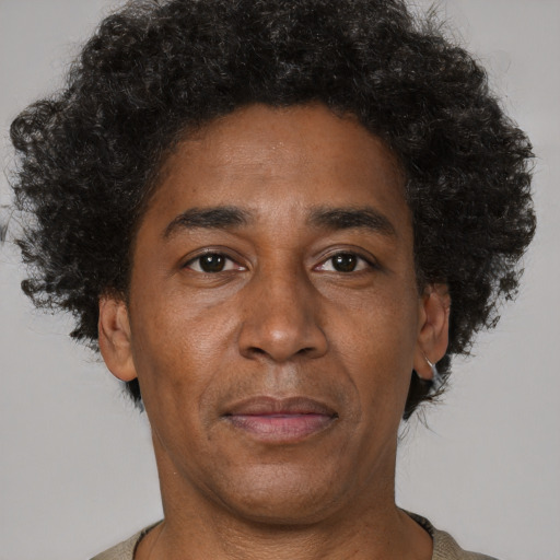 Joyful latino adult male with short  brown hair and brown eyes