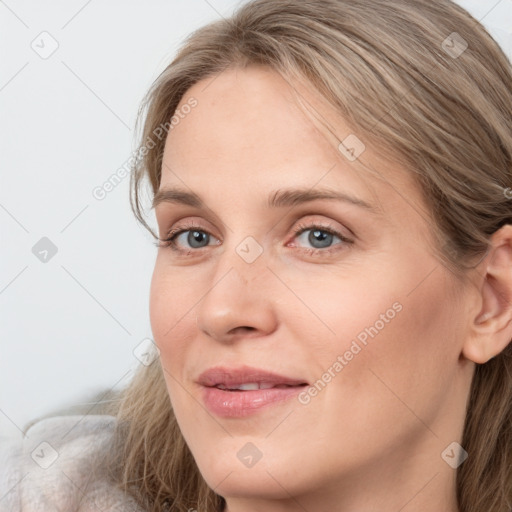 Joyful white young-adult female with long  brown hair and blue eyes