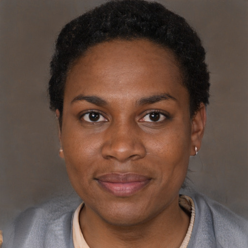 Joyful black adult female with short  black hair and brown eyes