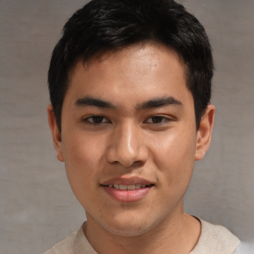 Joyful asian young-adult male with short  black hair and brown eyes