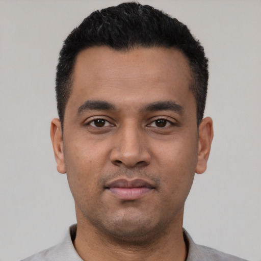 Neutral latino young-adult male with short  black hair and brown eyes