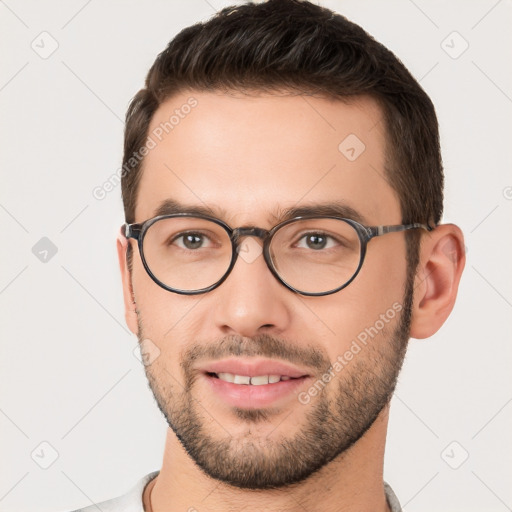 Joyful white young-adult male with short  brown hair and brown eyes