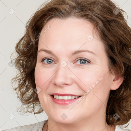 Joyful white young-adult female with medium  brown hair and blue eyes