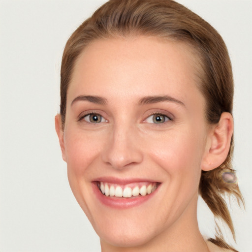 Joyful white young-adult female with medium  brown hair and blue eyes