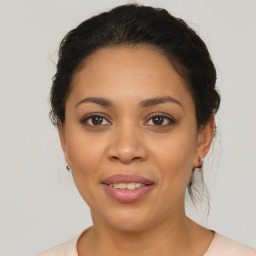 Joyful latino young-adult female with medium  brown hair and brown eyes