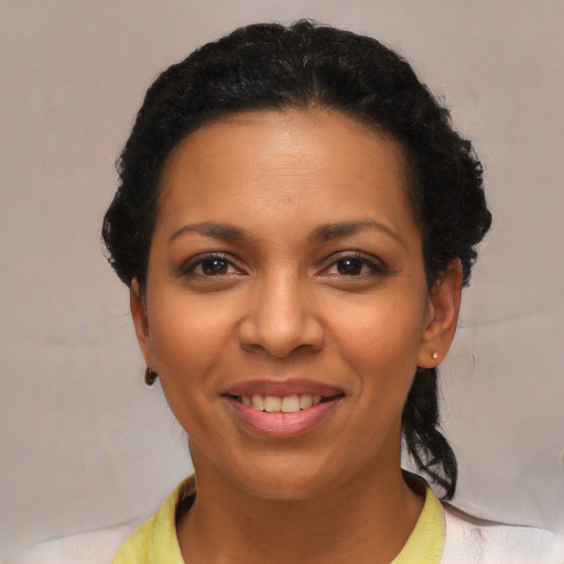 Joyful latino young-adult female with short  black hair and brown eyes