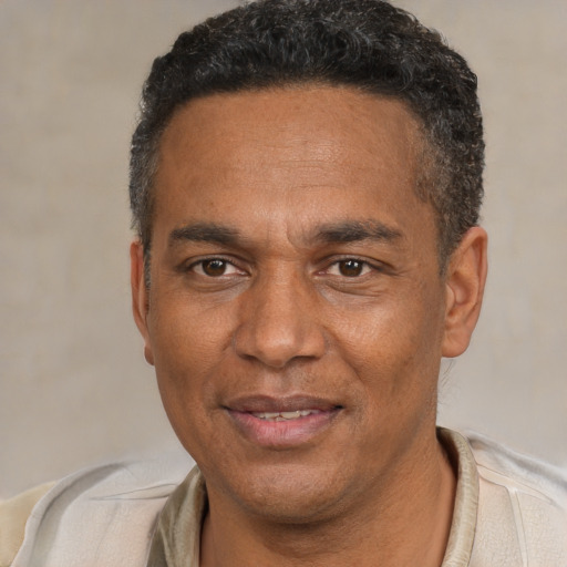 Joyful white adult male with short  black hair and brown eyes