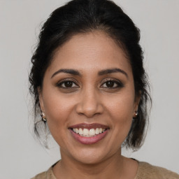 Joyful white young-adult female with medium  brown hair and brown eyes