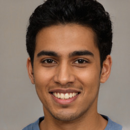 Joyful latino young-adult male with short  brown hair and brown eyes