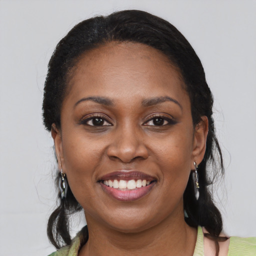 Joyful black young-adult female with medium  black hair and brown eyes