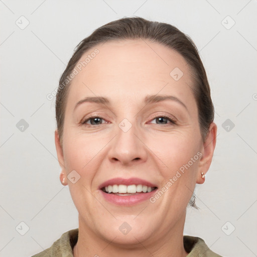 Joyful white adult female with short  brown hair and grey eyes