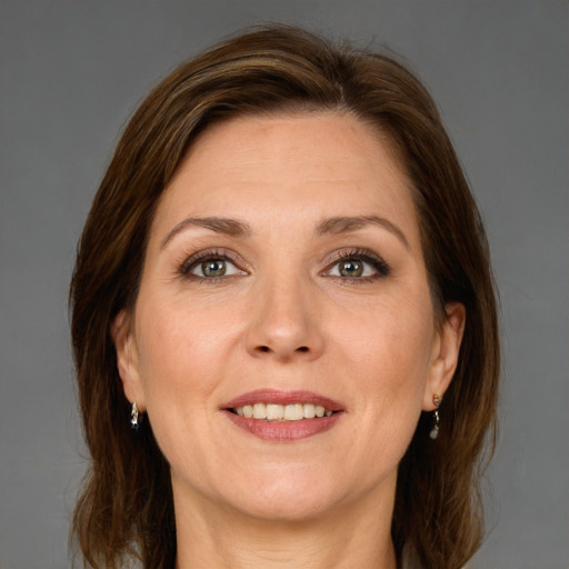 Joyful white adult female with medium  brown hair and grey eyes