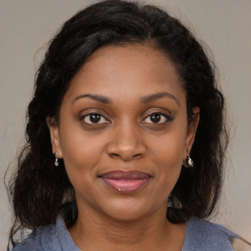 Joyful black young-adult female with medium  brown hair and brown eyes