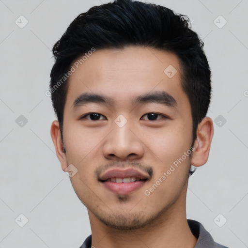 Joyful asian young-adult male with short  black hair and brown eyes