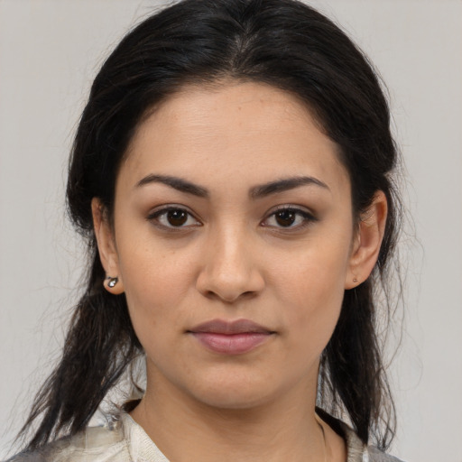 Joyful latino young-adult female with medium  brown hair and brown eyes