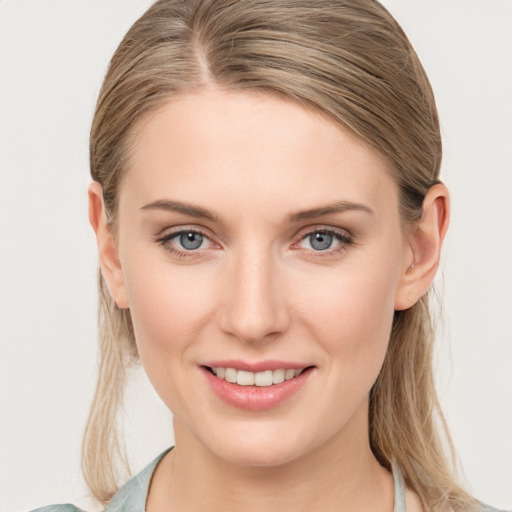 Joyful white young-adult female with medium  brown hair and blue eyes