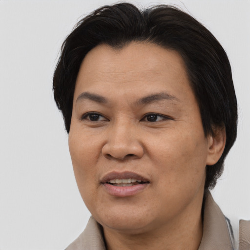 Joyful asian adult female with medium  brown hair and brown eyes