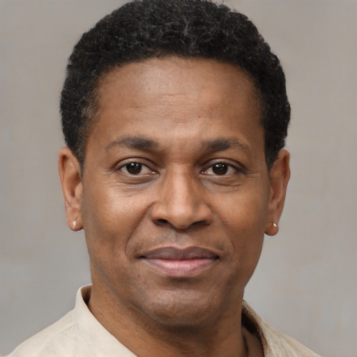 Joyful latino adult male with short  brown hair and brown eyes