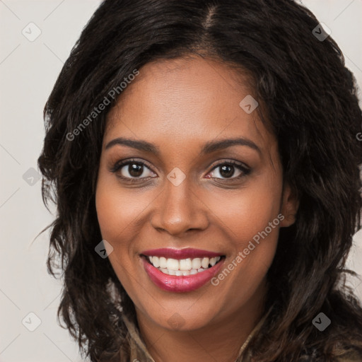 Joyful black young-adult female with long  brown hair and brown eyes