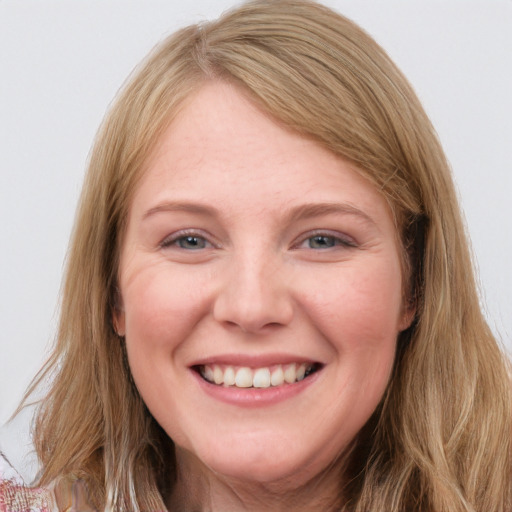 Joyful white young-adult female with long  brown hair and blue eyes