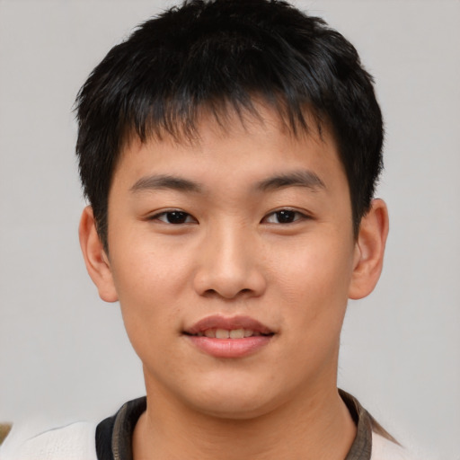 Joyful asian young-adult male with short  brown hair and brown eyes