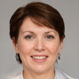 Joyful white adult female with medium  brown hair and grey eyes