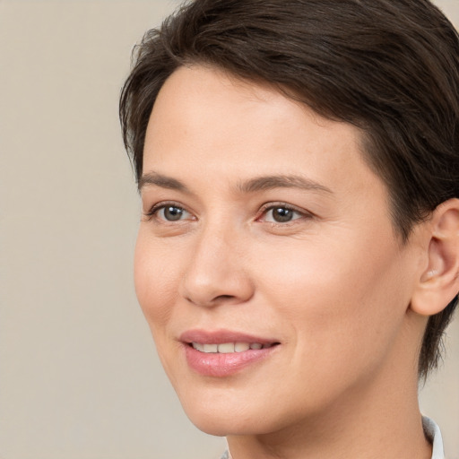 Joyful white young-adult female with medium  brown hair and brown eyes