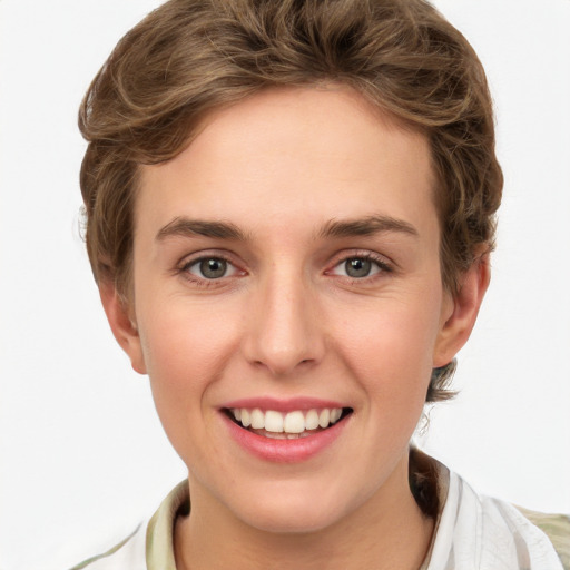 Joyful white young-adult female with short  brown hair and green eyes