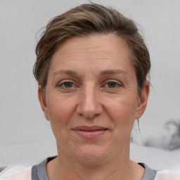 Joyful white adult female with short  brown hair and grey eyes